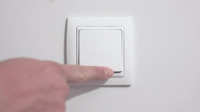 4K images of power consumption, video of a man's hand turning a wall switch on and off