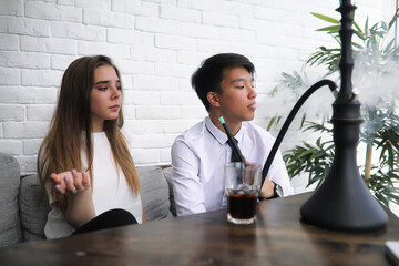 A pair of young people talking at the office