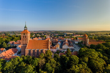 Fototapeta na wymiar Panorama of the city of Reszel at sunrise, Castle and the Church of the Holy Apostles Peter and Paul in Reszel - Warmia and Masuria, Poland