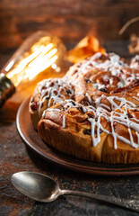Freshly baked sweet buns on black board on grey stone background