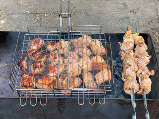 chicken kebabs on skewers, on the grill. coals and smoke. summer