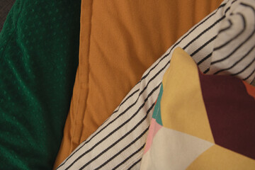 colorful pillows patterns stack on each other, cozy background