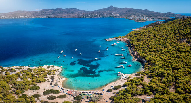 Panoramic aerial view of the popular beach of Moni island, next to the village Perdika on Aegina island with turquoise sea, Saronic Gulf, Greece
