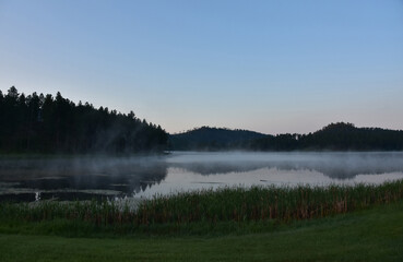 Fototapeta premium Fog Rising Off of Lake as the Sunrises