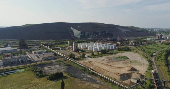 Aerial view Oil refinery with a man-made mountains.