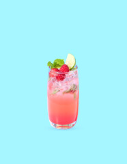 iced red raspberry punch cocktail with lime in glass on blue background. summer drink.