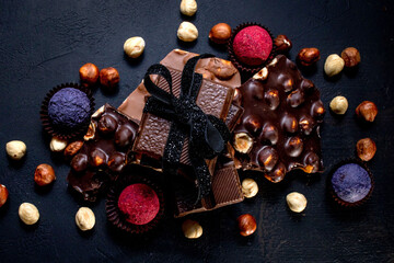 Chocolate bar, crushed pieces of dark chocolate and nuts. Praline Chocolate sweets