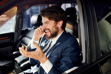 businessmen in a suit in a car a trip to work rich