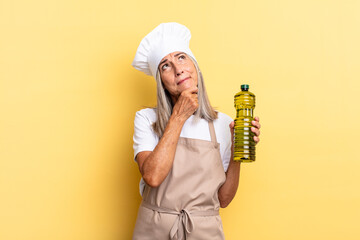 middle age chef woman thinking, feeling doubtful and confused, with different options, wondering...