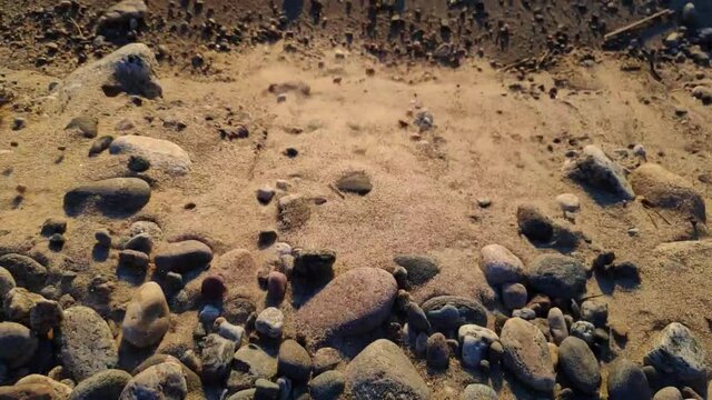 stones falling in the sand