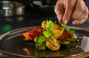 Chef prepares a dish with vegetables