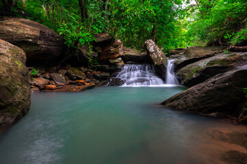 Native picturesque waterfall,Small Waterfall in deep forest,Ubon Ratchathani province,Thailand.leaf moving low speed shutter blur.