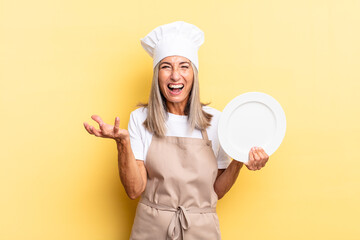 middle age chef woman looking angry, annoyed and frustrated screaming wtf or what’s wrong with...