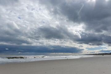 Fototapeta na wymiar Threatening skies and empty east coast beach in early winter