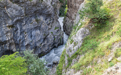 A fast mountain river flows in a mountain gorge