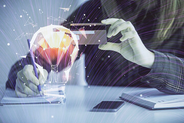 Multi exposure of woman on-line shopping holding a credit card and bulb drawing. Choice concept.
