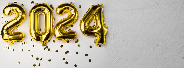 gold foil new year balloons 2024. New Year's digit number two thousand twenty four. Golden on a...