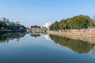 The city's buildings are reflected in the river