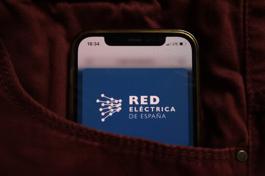 KONSKIE, POLAND - September 04, 2021: Red Electrica Corporacion SA logo on mobile phone hidden in jeans pocket