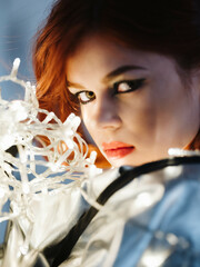 woman with bright makeup garland near face fashion posing close-up