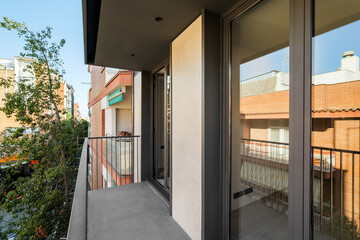 A balcony in modern building of Barcelona with reflection in window