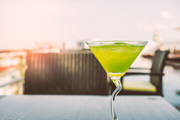 Green iced cocktail on the glass table as welcome drink in the hotel which can make visitor feel fresh with copy space