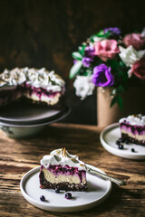 Chocolate blueberry cheesecake. A  part of piece of cheesecake in focus.