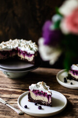 Chocolate blueberry cheesecake. A  part of piece of cheesecake in focus.