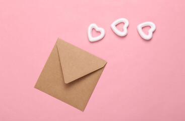 Envelope with white hearts on a pink background. Creative layout. Love concept, happy valentines day