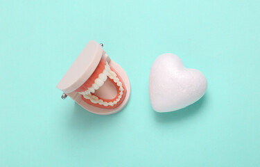 Plastic model of  jaw with heart on a blue background