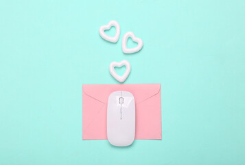 Love letter. Envelope with pc mouse and hearts on a blue background
