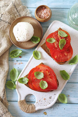 Beef heart tomato toast with olive oil, basil and mozzarella, two servings