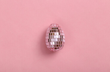 Mirror egg on a pink background. Minimal party, Easter concept