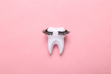 Tooth with eyelashes on pink background. Minimal concept art