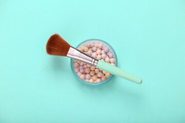 Powder Balls with makeup brush on blue background. Cosmetics. Top view