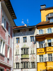Bolzano, Bozen, August 2021, Dolomites, Alpine mountain region, South Tirol, Alto Adige, Row of houses, Painted walls, Street, Town, Italia, Italy, Europe.