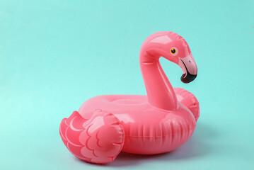 Pink inflatable flamingo on a blue background