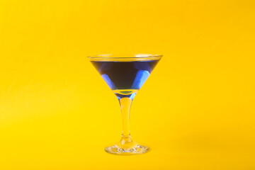 Margarita blue cocktail on yellow background