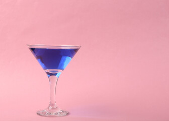 Margarita blue cocktail on pink background. Copy space