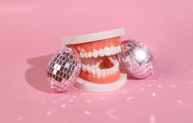 Jaw with mirrored eggs on a pink background. Easter minimal composition