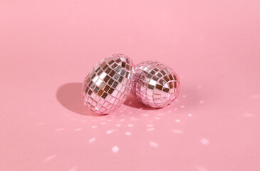 Disco ball, mirrored eggs on pink background. Easter celebration concept