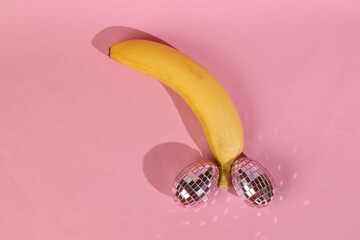Panan with mirrored eggs on a pink background. Male genital shape