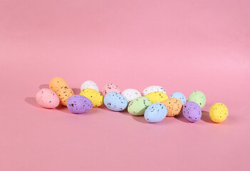 Colored Easter eggs on a pink background. Minimal easter layout