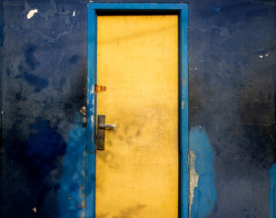 blue wall with yellow door.