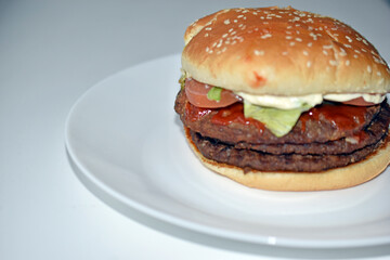 Double juicy meat burger on a white plate