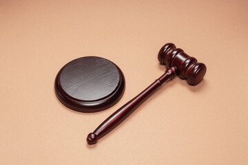 Gavel down on stand on brown background. Justice of law system conceptual.