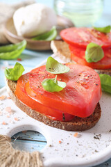 Beef heart tomato toast with olive oil, basil and mozzarella, two servings