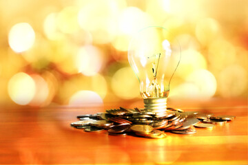 gruop of coins with light bulb multi color abstract background
