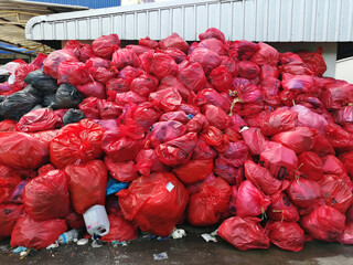 group of infectious waste from covid 19 patient in red plastic bag
