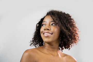 African beauty woman. A Young Beautiful African American Woman With Healthy Skin and Long Eyelashes is Smiling. 

Black Model isolated on a Background in Beauty Concept.